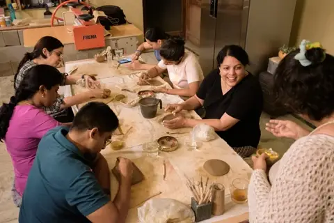 A full table of makers slab-building side by side