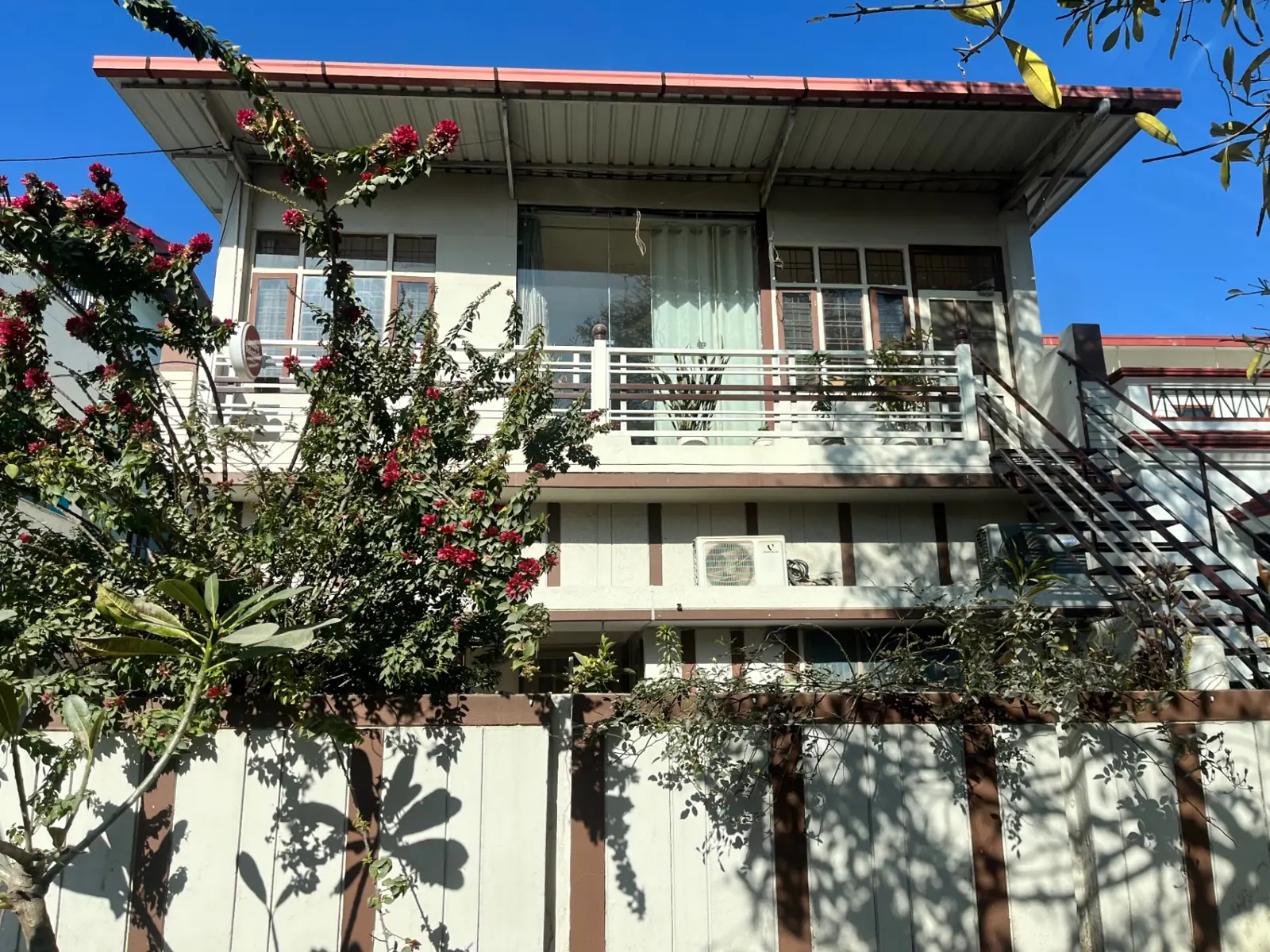 The Lumiere Bakestudio building in Indira Nagar, framed by bougainvillea