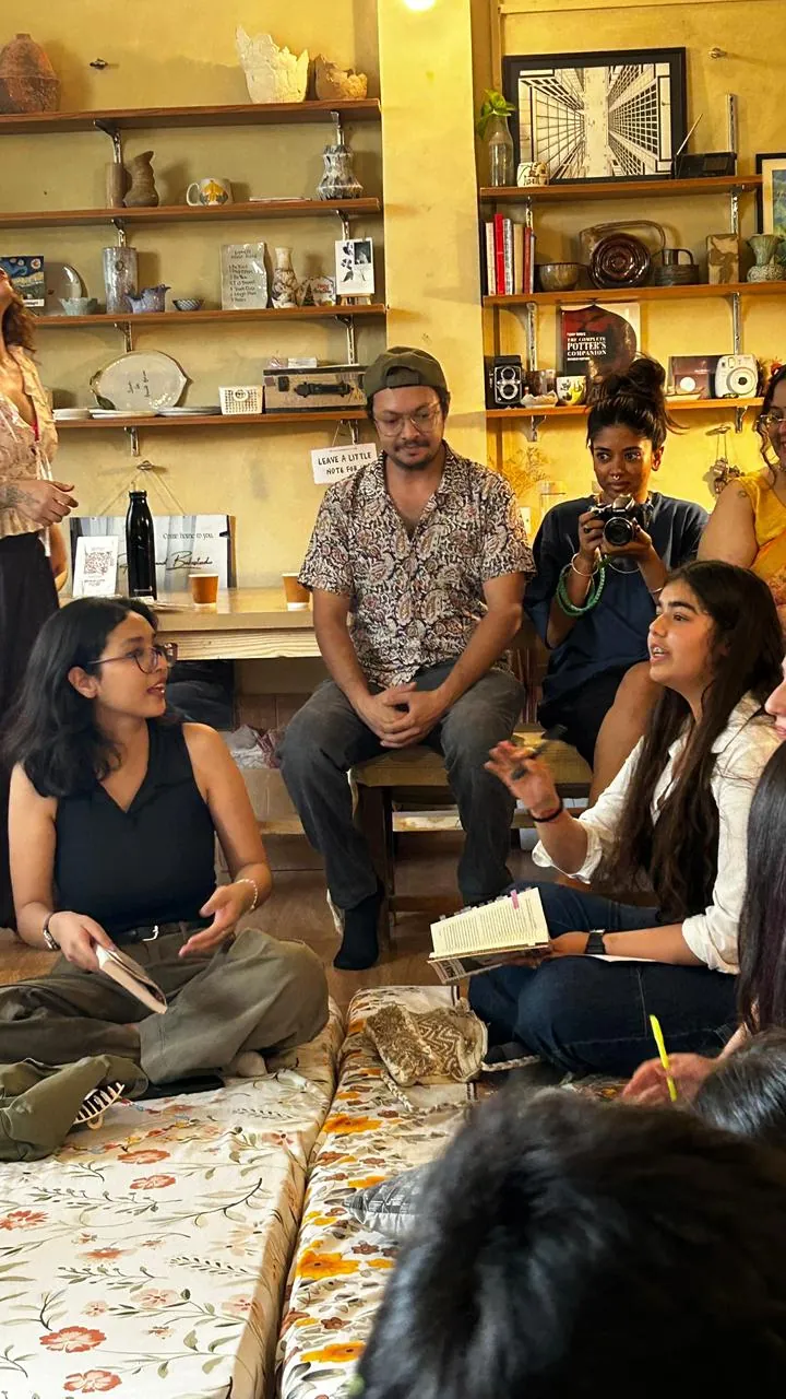 A reading circle seated on the studio floor during Khuli Kitaab