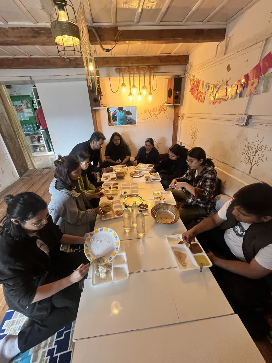 The whole group painting together around the long dining table
