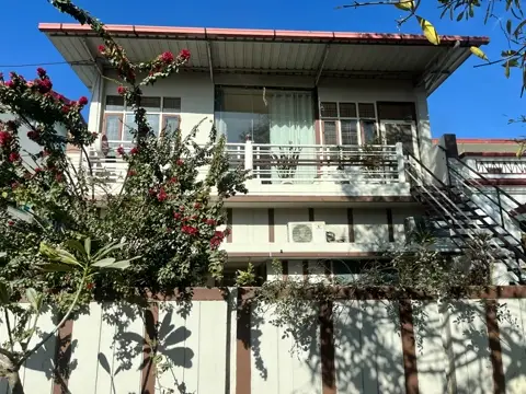 The Lumiere Bakestudio building in Indira Nagar, framed by bougainvillea