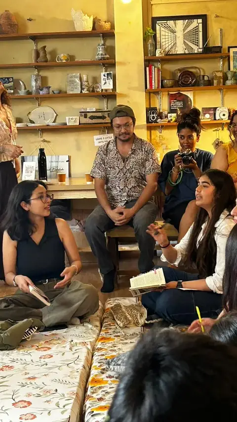 A reading circle seated on the studio floor during Khuli Kitaab