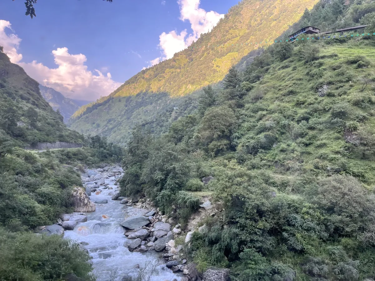 The Sainj river running below the village, prayer flags on the ridge