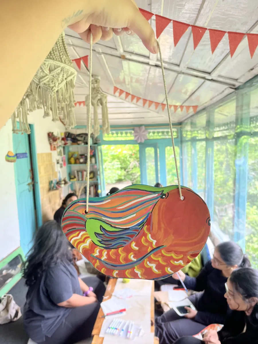 A hand-painted fish mobile hanging in the verandah while guests paint