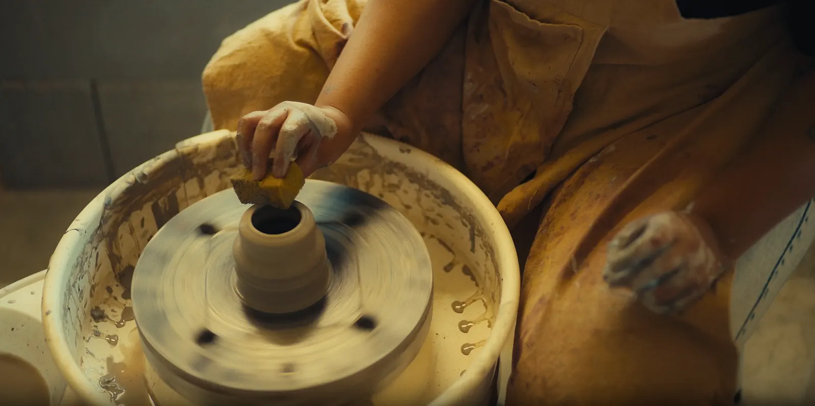 Hands shaping clay during the Month-Long Ceramics Course