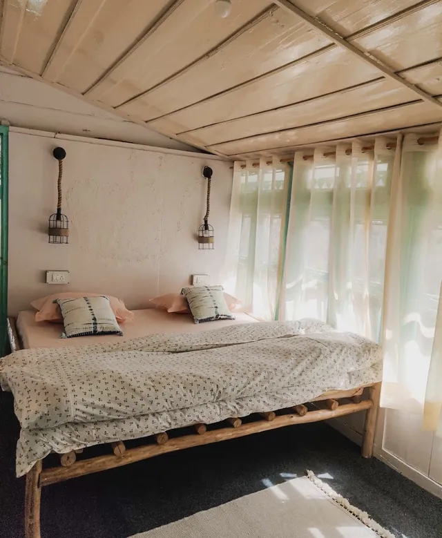 Morning light through sheer curtains in the double room at The Nook